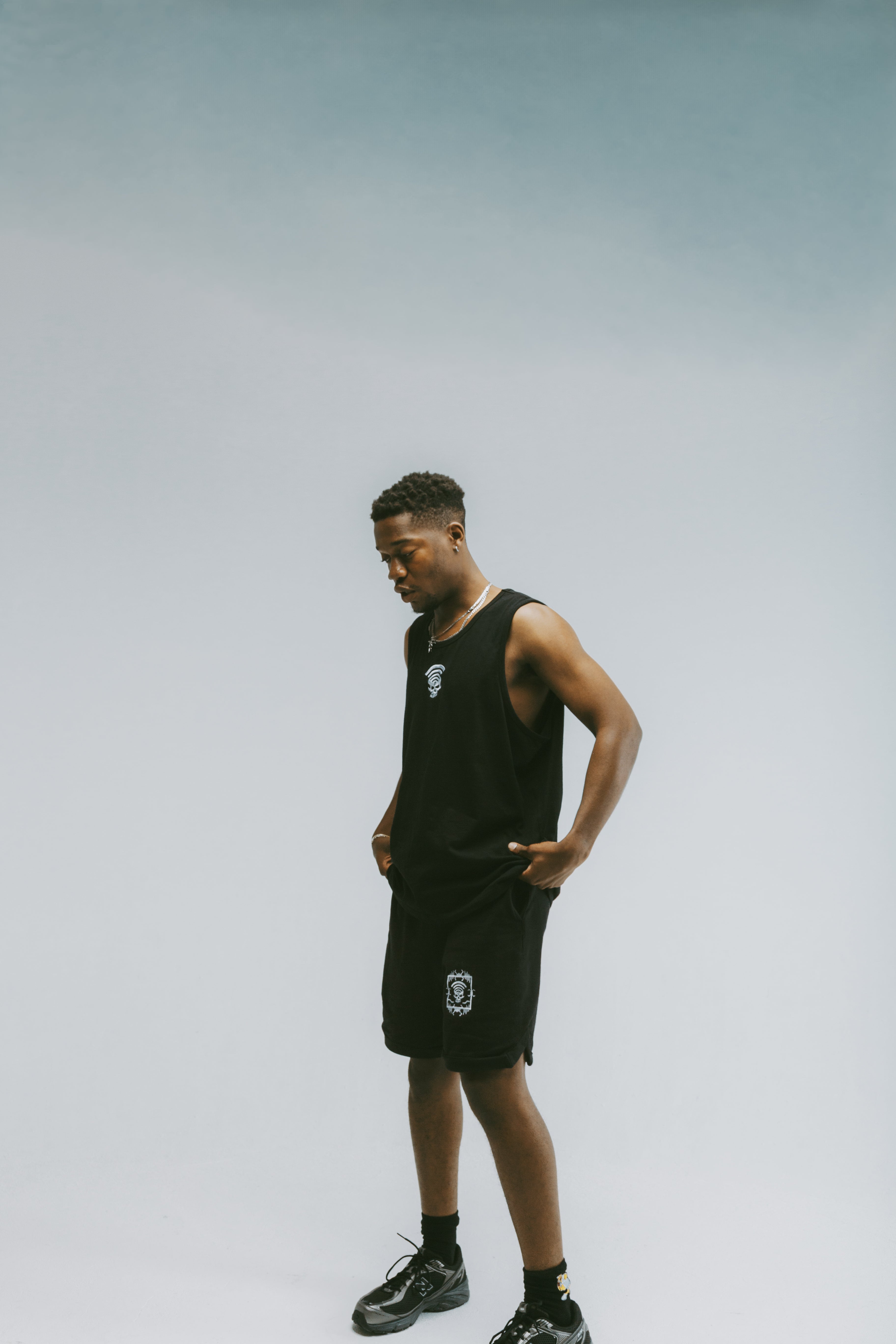 Man wearing Disconnected Shorts in black cargo style — front view.  Model wearing Disconnected Shorts black cargo shorts — streetwear fit front angle.