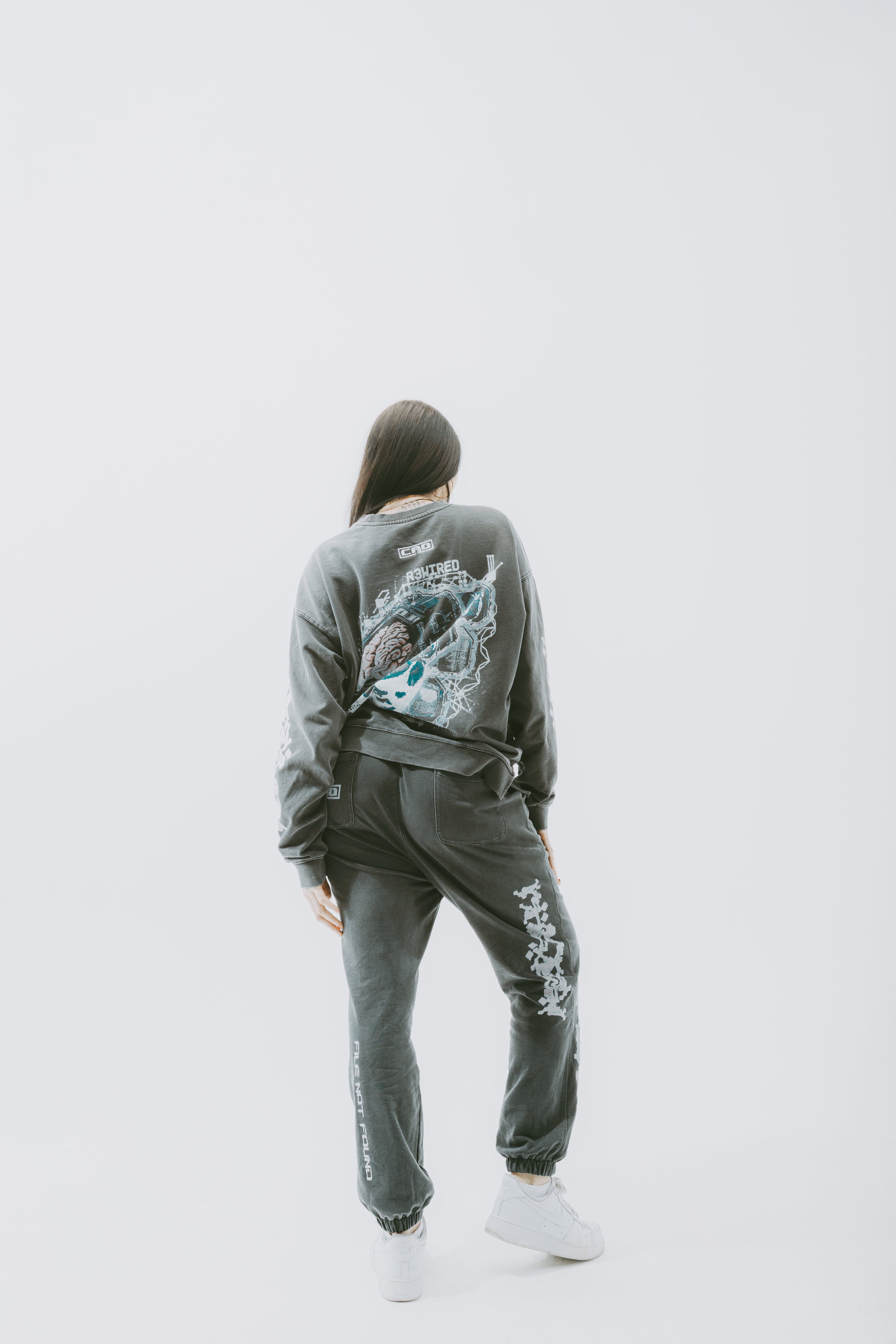 Model wearing Safe Storage Joggers Eclipse Grey with a relaxed oversized fit and stylish design, showing the back view.