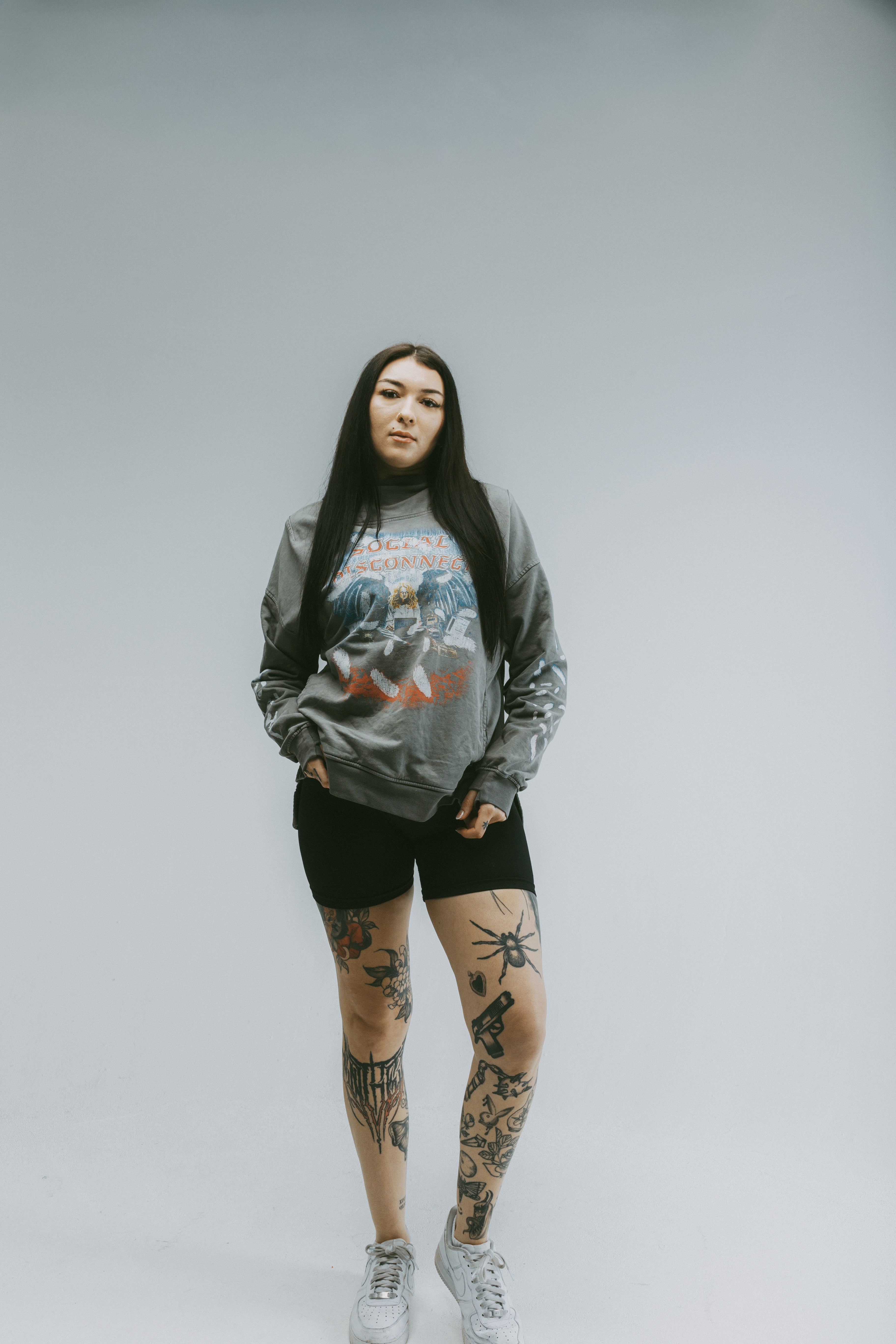 Model wearing the Social Disconnect Hoodie, a black streetwear hoodie, showcasing a trendy and loose fit style.